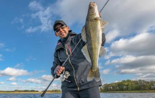 Man posing with his Ontario fish.